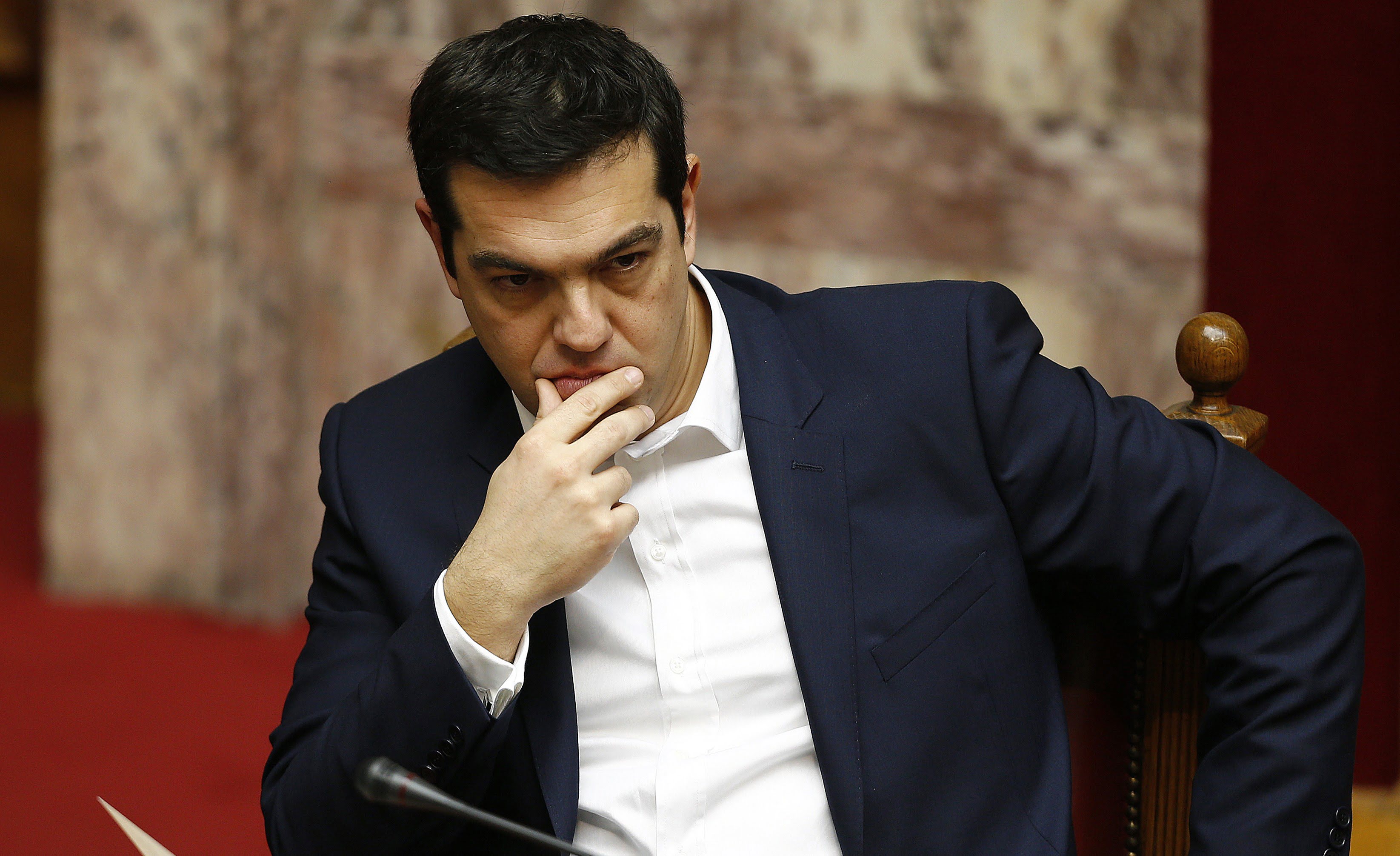 Greek Prime minister Alexis Tsipras reacts before a swearing in ceremony for Greece's new lawmakers in the Greek parliament in Athens February 5, 2015. REUTERS/Yannis Behrakis (GREECE - Tags: POLITICS) - RTR4OCA9
